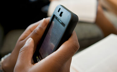 hands holding mobile device