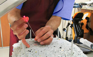 man threading needle