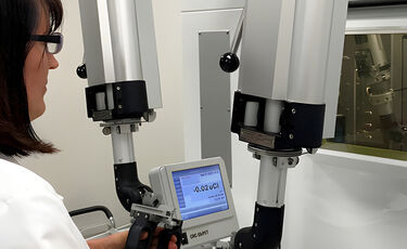 Clinician working with robotic arms